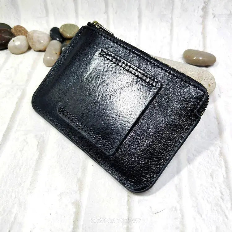 Mini zipper waist bag in black leather with front card pocket and zip closure