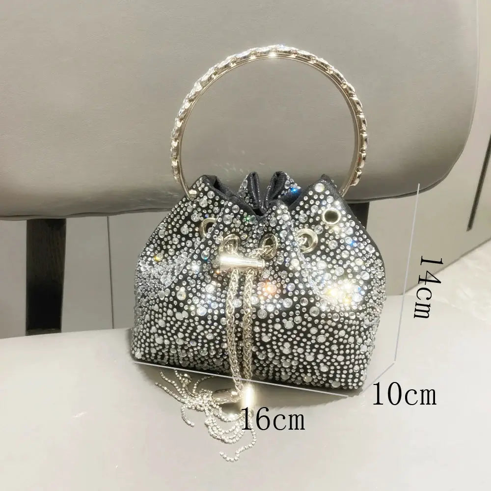 Simples Market rhinestone evening clutch, silver crystal-dotted bucket bag with circular jeweled handle.