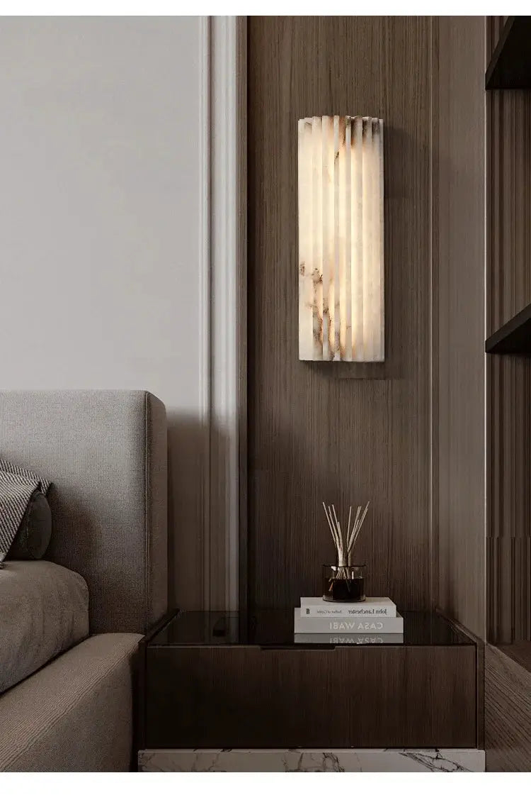 Marble wall lamp by Simples Market, modern minimalist Italian-style bedside sconce with warm glow.