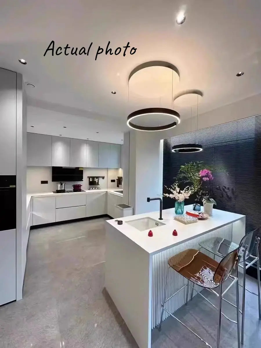 Ring ceiling chandelier pendant lamp; modern black LED rings suspended over a white kitchen island (2 rings)