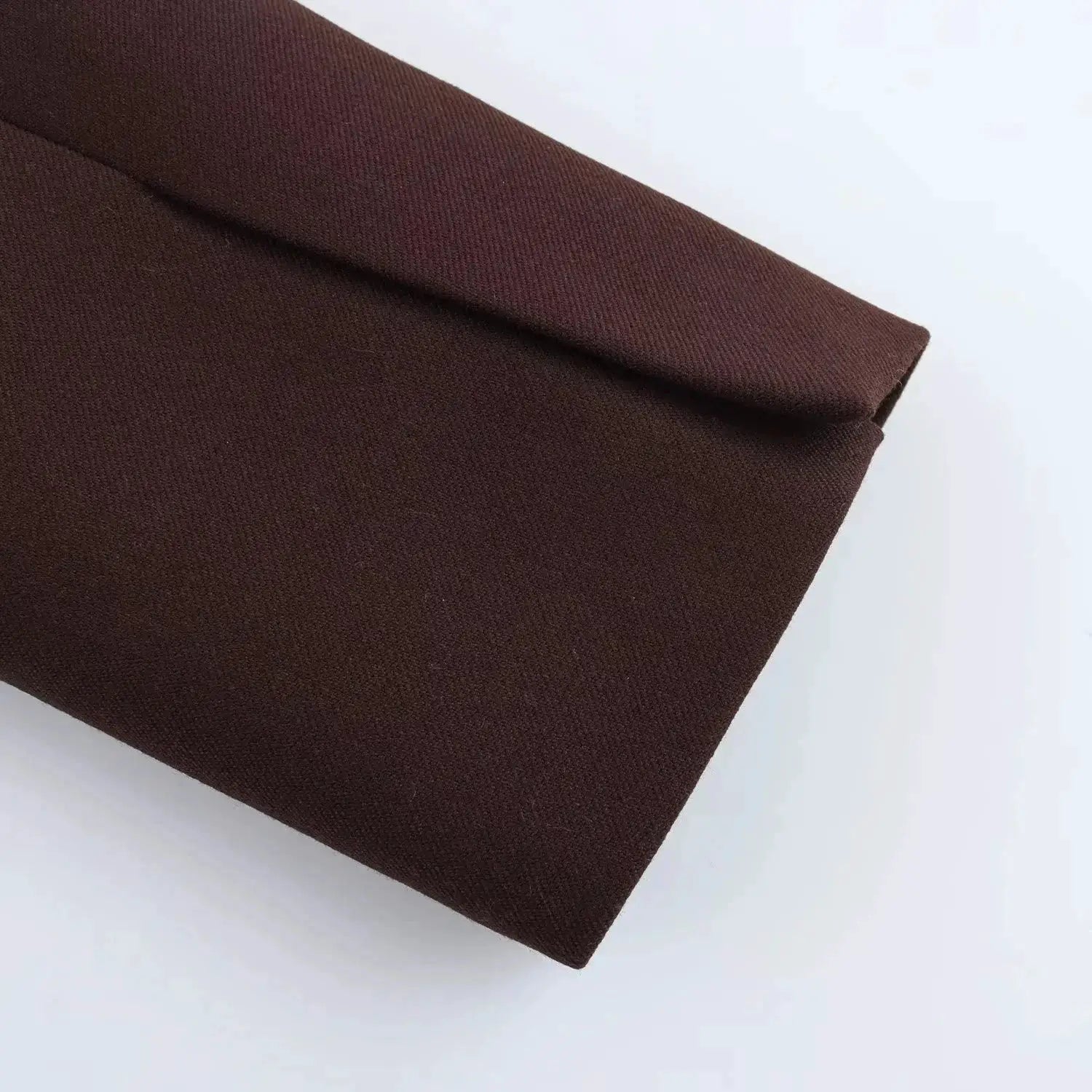 Brown blazer fabric close-up with folded sleeve, Simples Market KONDALA collection