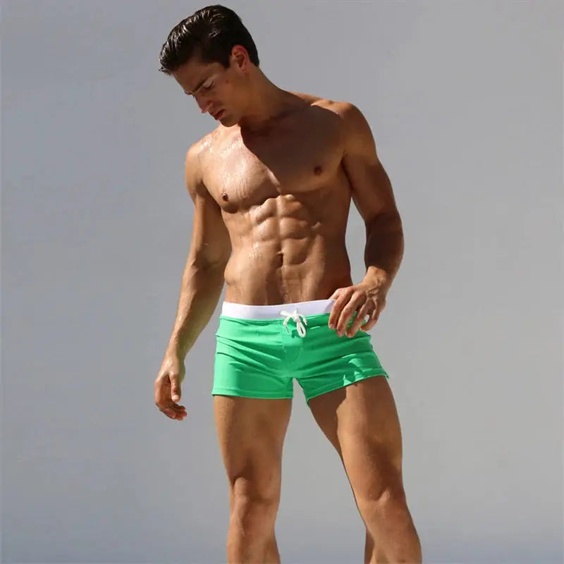 Men's green swim trunks with white drawstring by Simples Market