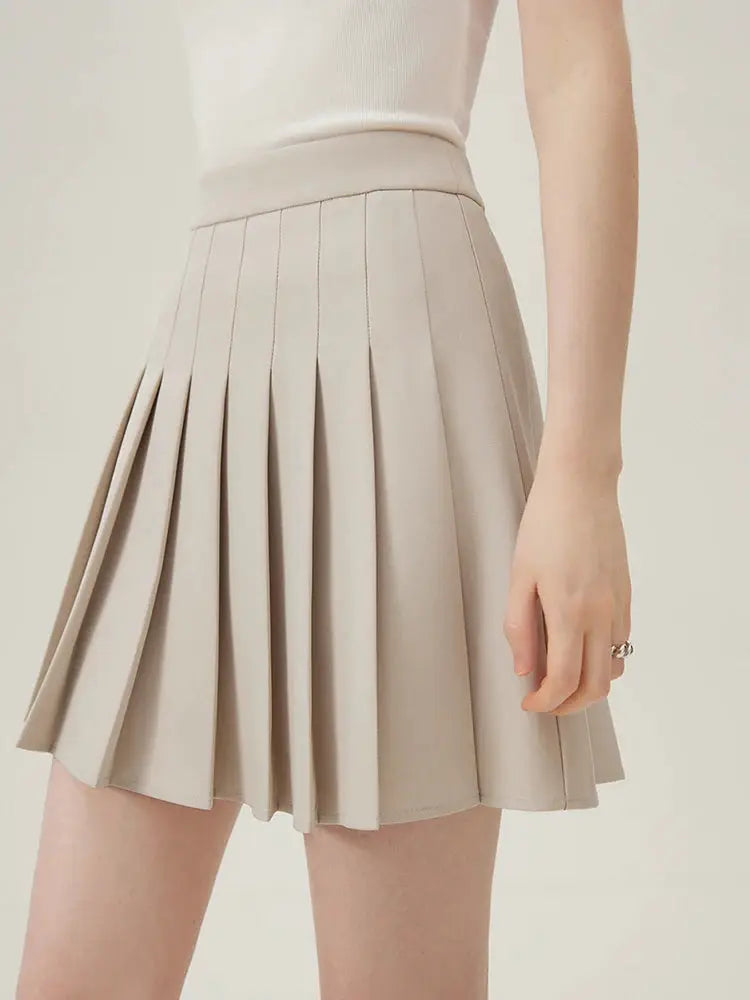 Women's beige pleated mini skirt with a structured waistband.