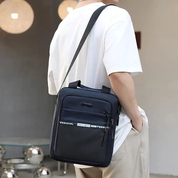 Men's navy crossbody bag with adjustable strap and front zip pocket