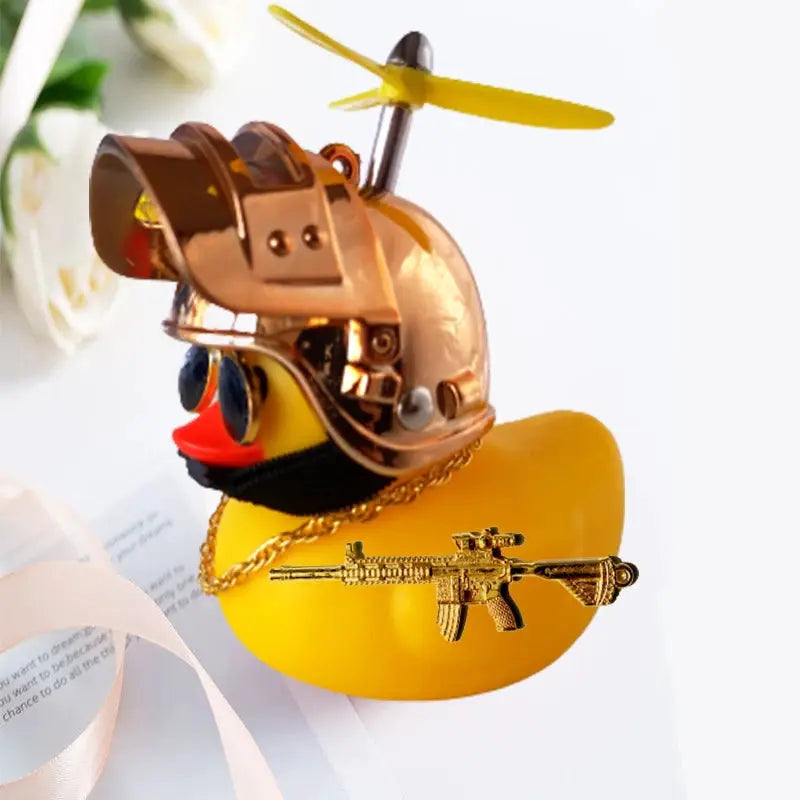 Yellow rubber duck car decor with bronze helmet and gold rifle charm