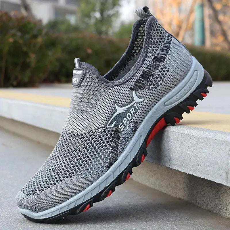 Men's sport mesh sneakers by Simples Market in grey breathable knit upper with red and black traction outsole.