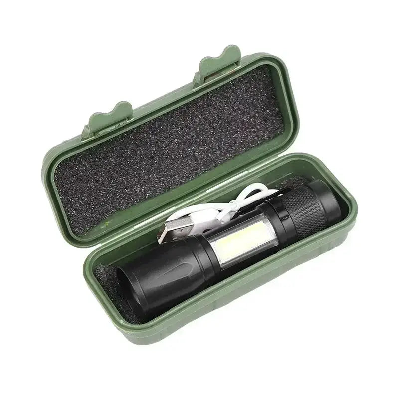 Flashlight with LED panel, black body in a green protective hard case and USB charging cable