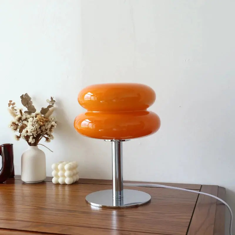 Macaron glass table lamp with orange double-ring shade on chrome pedestal; ideal nightstand or living room decor.