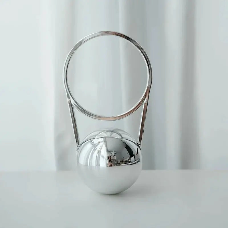 Silver acrylic evening clutch with ball handle and circular metal ring