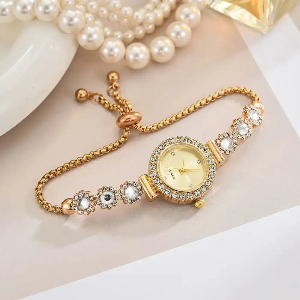Gold-tone women's rhinestone watch with flower-embellished bracelet and quartz movement