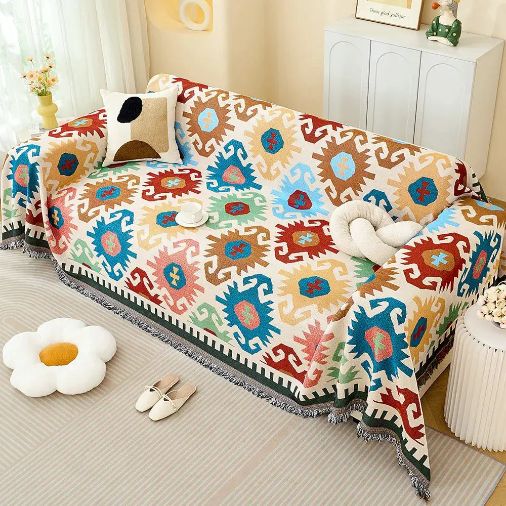 Simples Market sofa throw blanket with full-coverage multicolor geometric pattern and fringed edge