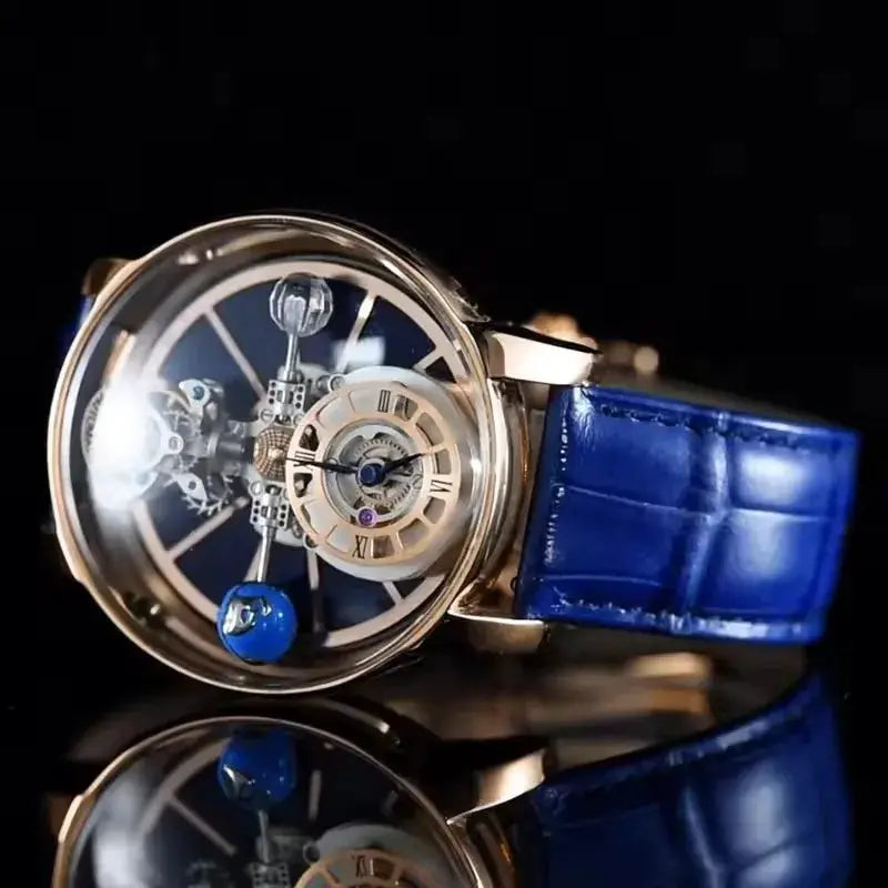 PINDU Design men's wristwatch with transparent skeleton dial, gold-tone case, blue leather strap