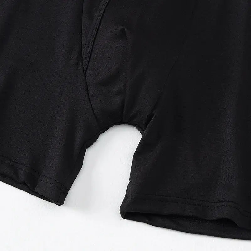 Men's black boyshort underwear by Simples Market, elastic waistband, close-up of leg opening showing smooth fabric.