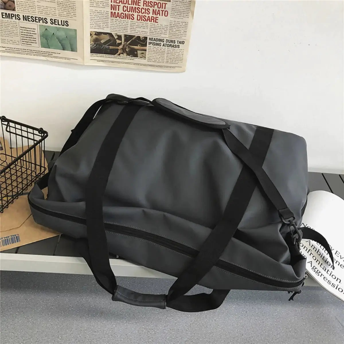 Handheld travel bag by Simples Market, large-capacity gray duffel with black straps and side zipper pocket.