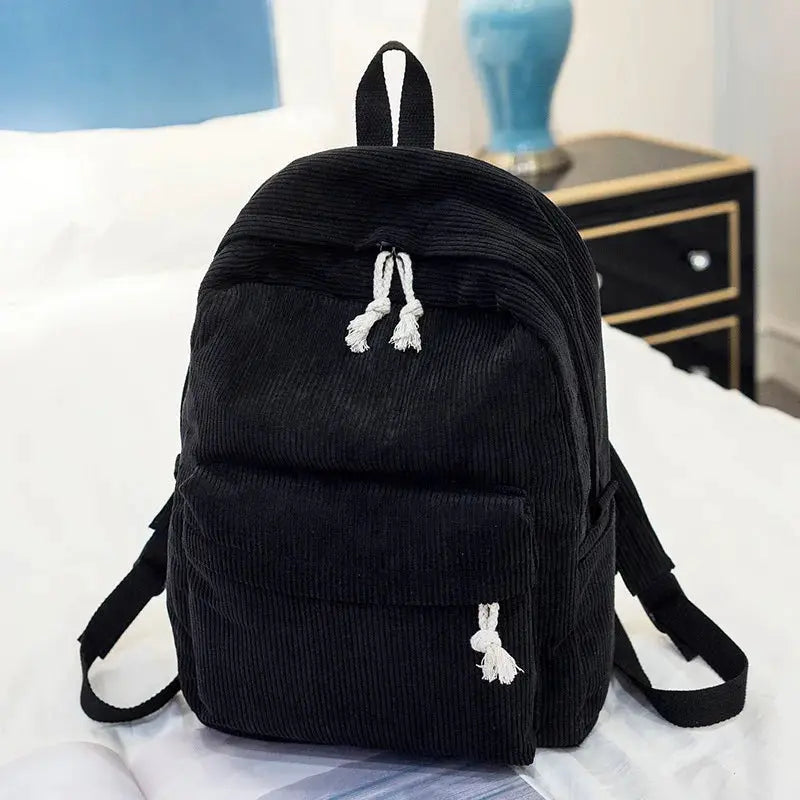 Backpack for kids, black corduroy with white tassel zipper pulls and front pocket
