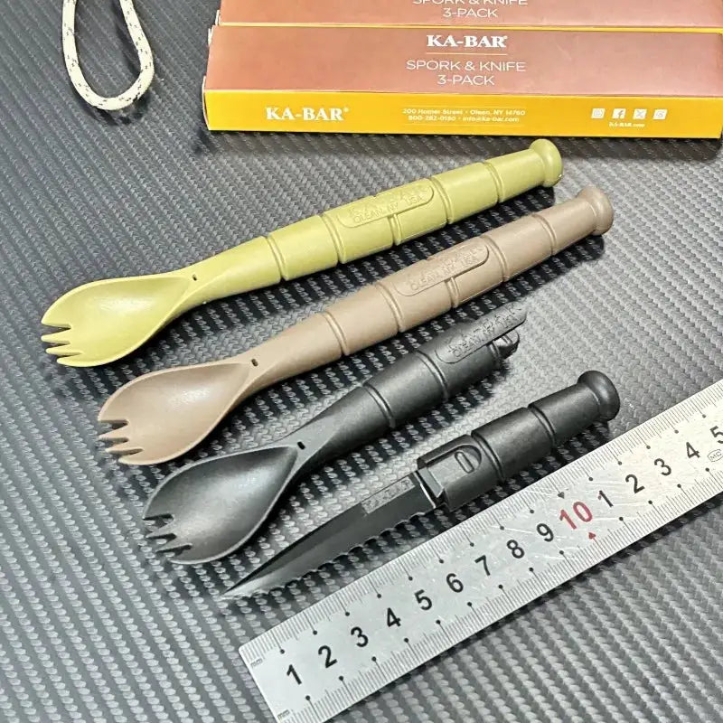 4-piece tactical mini cutlery set with spoon-fork-knife sporks in olive green, tan, brown, and black; KA-BAR packaging visible.