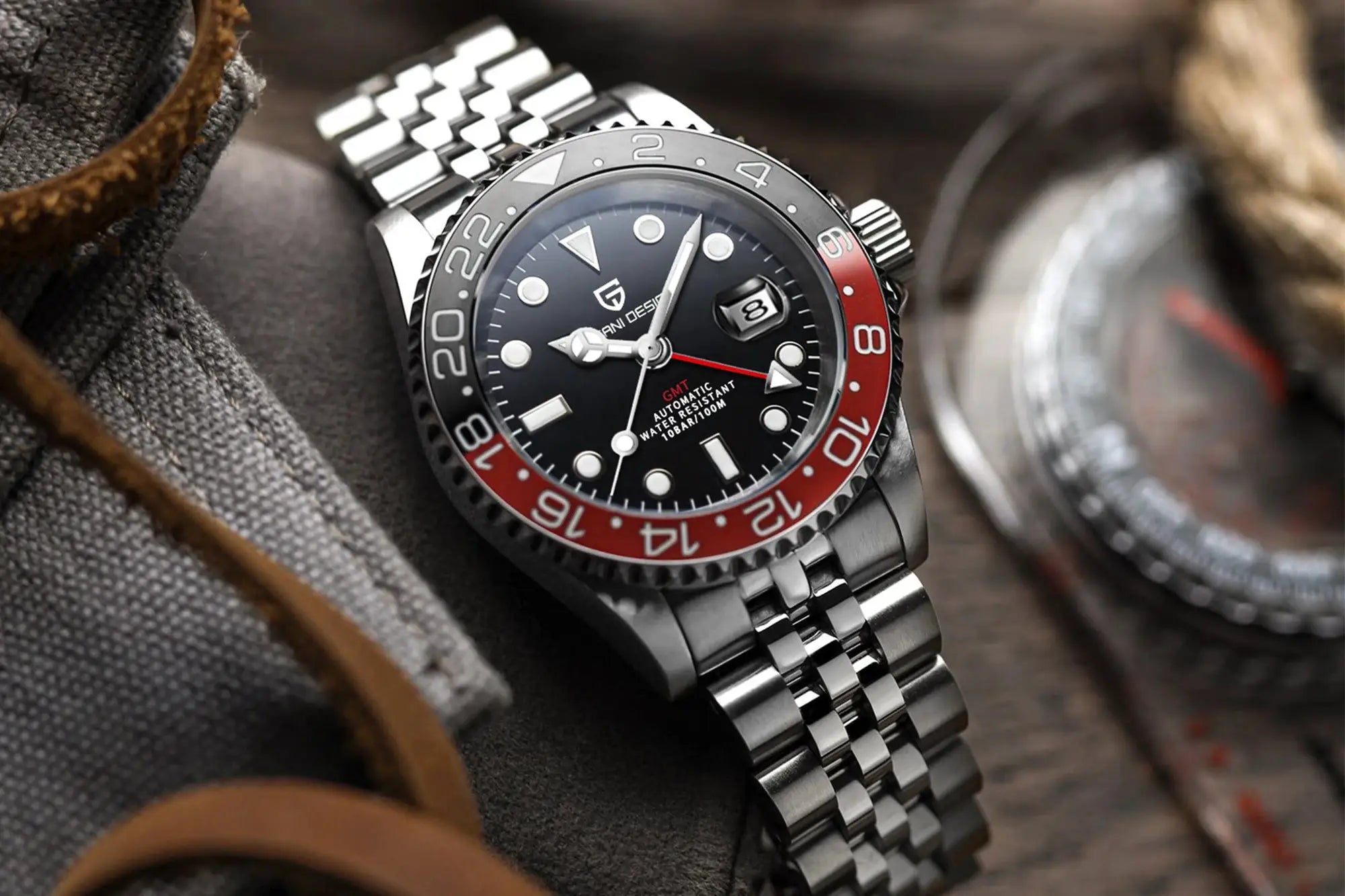 PAGANI DESIGN GMT watch with stainless steel bracelet, black dial, red/black bezel, date magnifier