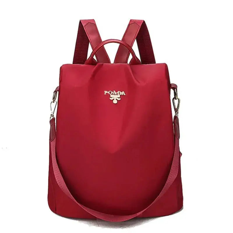 Red women's Oxford cloth backpack with top handle and detachable shoulder strap; waterproof, large-capacity travel bag.