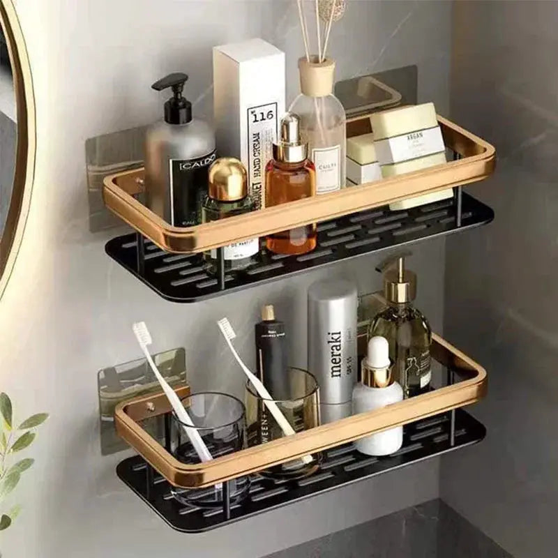 Two-tier aluminum alloy bathroom shelf organizer with tan top rail and black bottom rack, holding toiletries