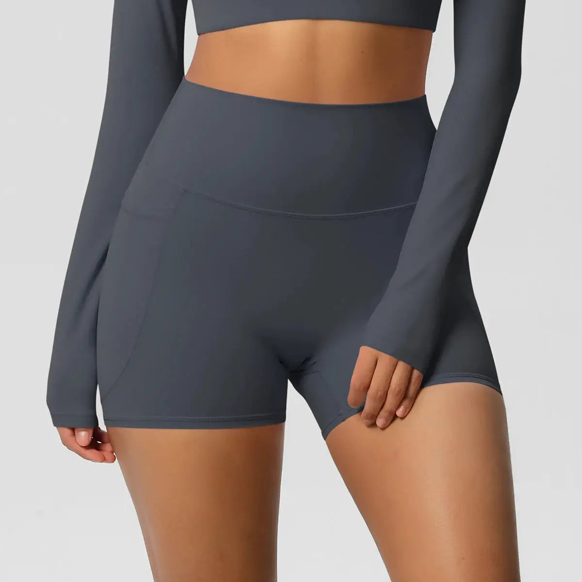 Women’s pocketed high-waist yoga shorts by Simples Market in dark gray.