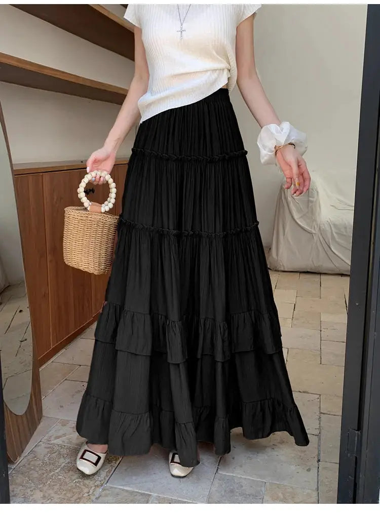 Black tiered maxi skirt with ruffle hems, high-waist, flowy layered silhouette