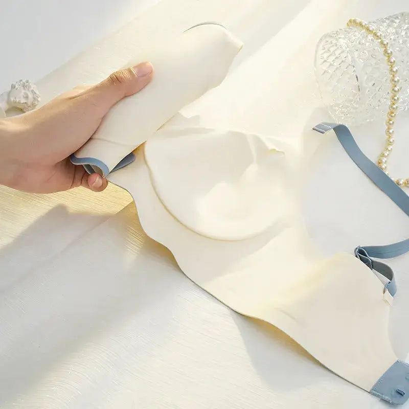 Cream thin push-up bra for women with contrasting blue-gray adjustable straps.