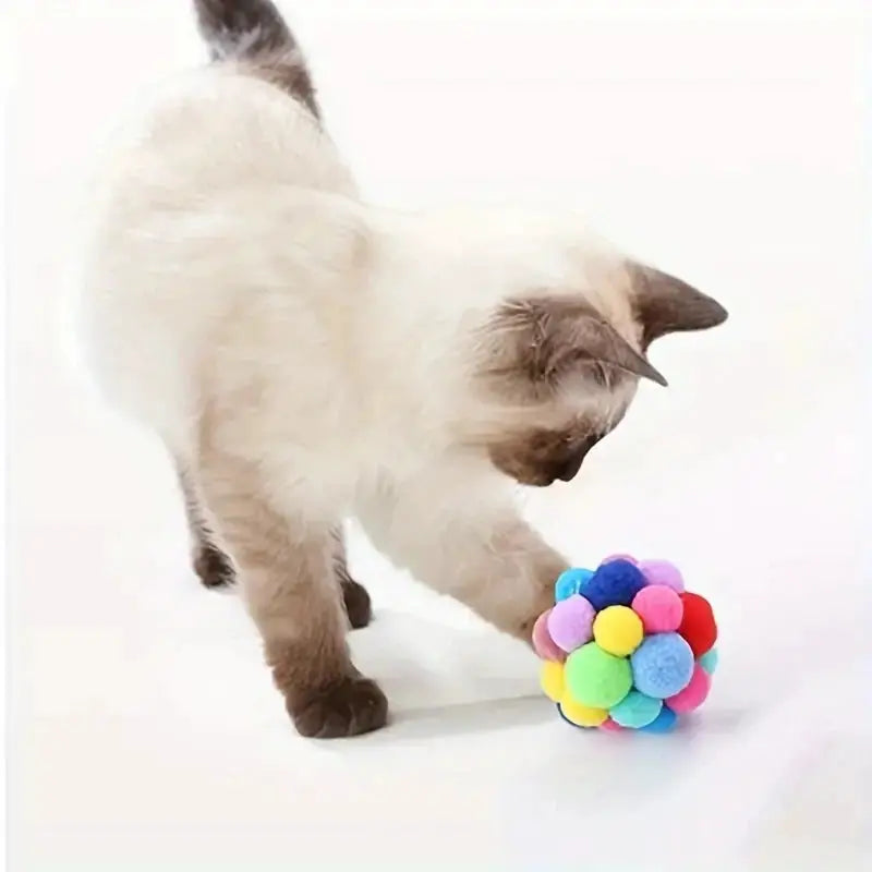 Cat plush ball toy with colorful woolen pom-poms for interactive play
