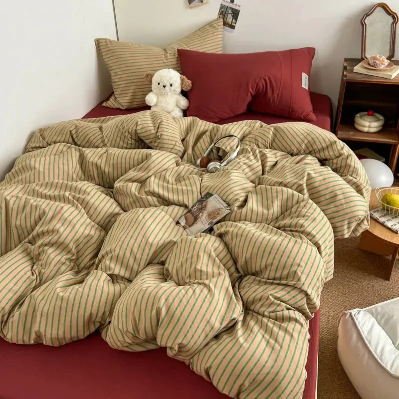 Beige striped bedding set with duvet cover and pillowcases on a red bed, includes bedsheet