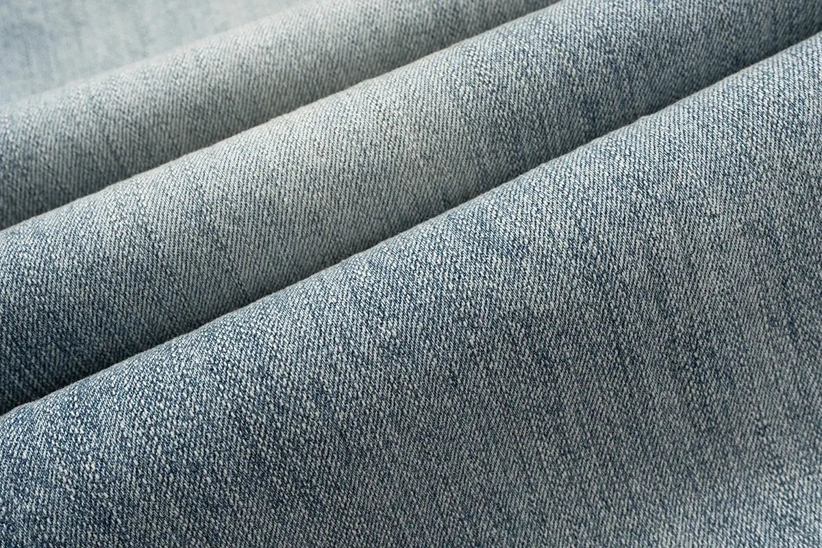 Blue denim jeans fabric close-up showing classic twill texture