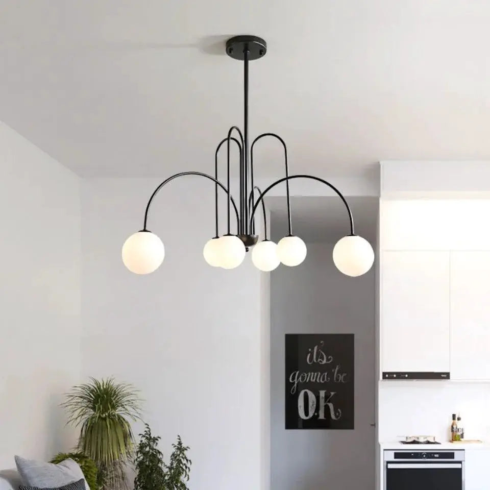 Nordic minimalist multi-globe pendant light with black metal arcs and white glass bulbs, modern living room chandelier.