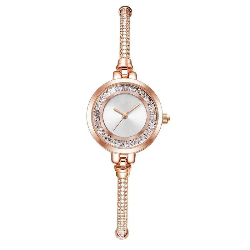 Wristwatch by Simples Market rose-gold with crystal-studded bezel, small dial, steel bracelet.