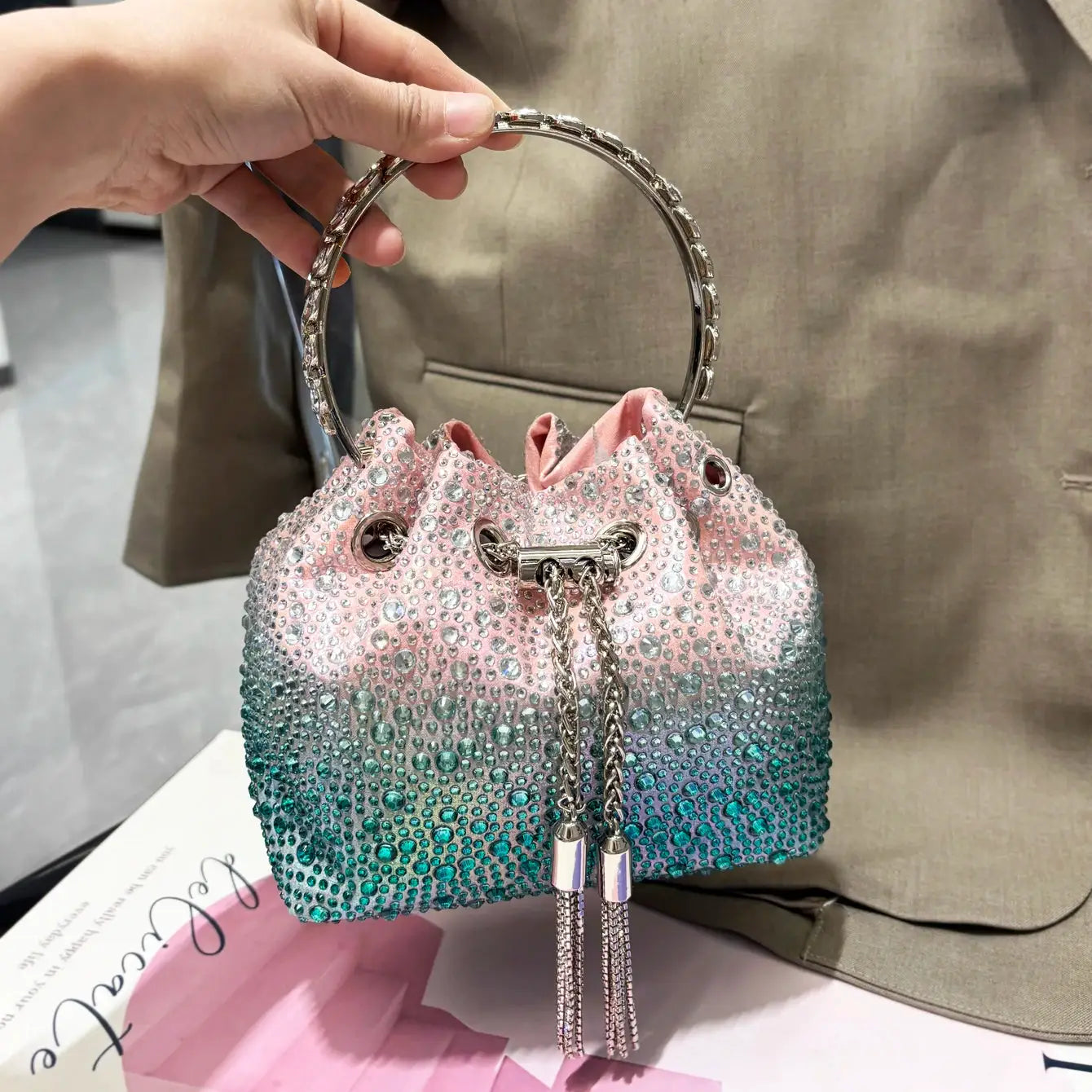 Simples Market rhinestone evening clutch, gradient pink–teal crystal-embellished bucket bag with silver ring handle