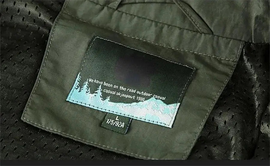 Sleeveless jacket vest in olive green with mesh lining and interior patch featuring mountain design