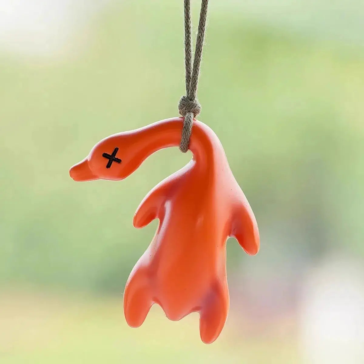 Color-changing roast duck pendant on cord; UV-sensitive orange keychain pendant
