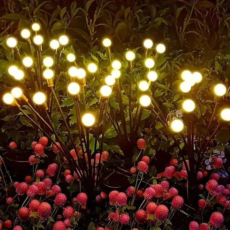 10-light solar lawn garden lamp set with LED wind-driven firefly globes on stakes in a flower bed