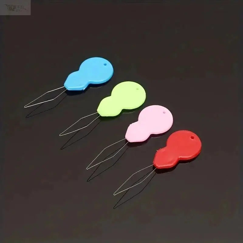 Plastic needle threaders, colorful hand-sewing tools; four-piece set in blue, lime, pink, and red.