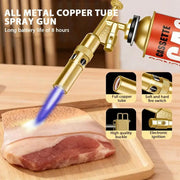 Outdoor welding gas torch with a gold metal body and blue flame, used for BBQ and welding.