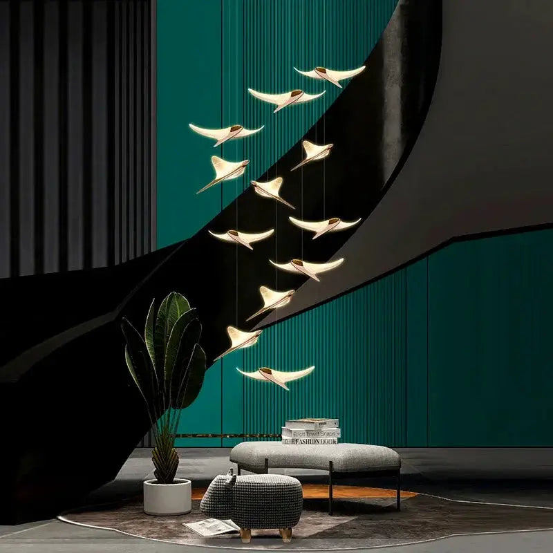 Seagull staircase pendant lamp by Simples Market; gold-toned bird-shaped pendants along a curved staircase.