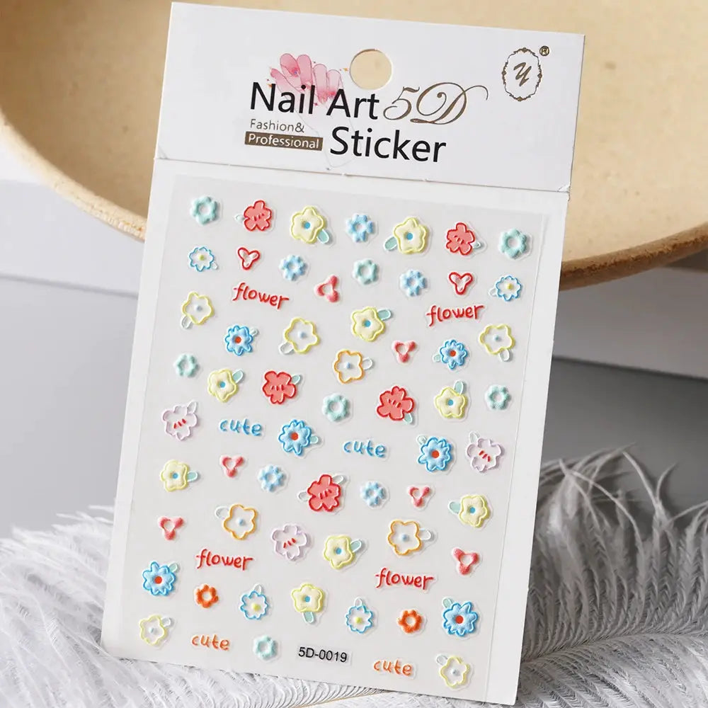 1pc nail art sticker sheet by Simples Market with pastel flower motifs and cute text for manicure decor.
