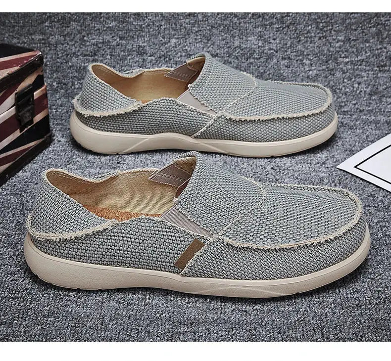Men's gray canvas slip-on loafers with beige sole, lightweight casual pair