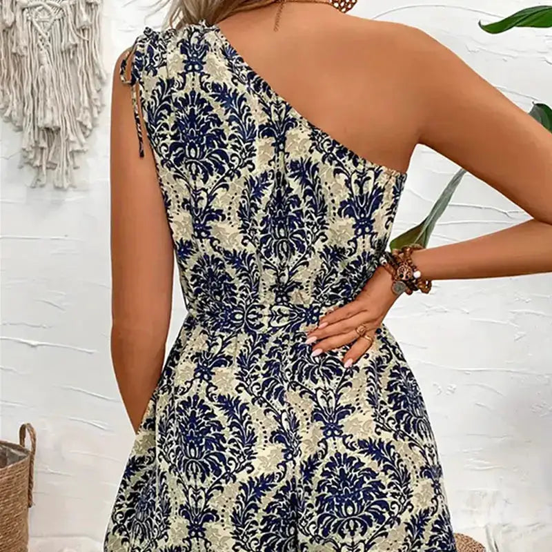 Women's jumpsuit by Simples Market with navy botanical print on cream background, boho summer casual wear.