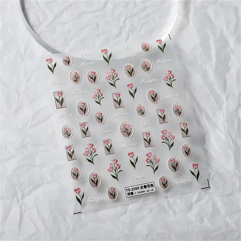 Nail art sticker sheet with pink tulip floral decals and small framed floral accents for self-adhesive manicure