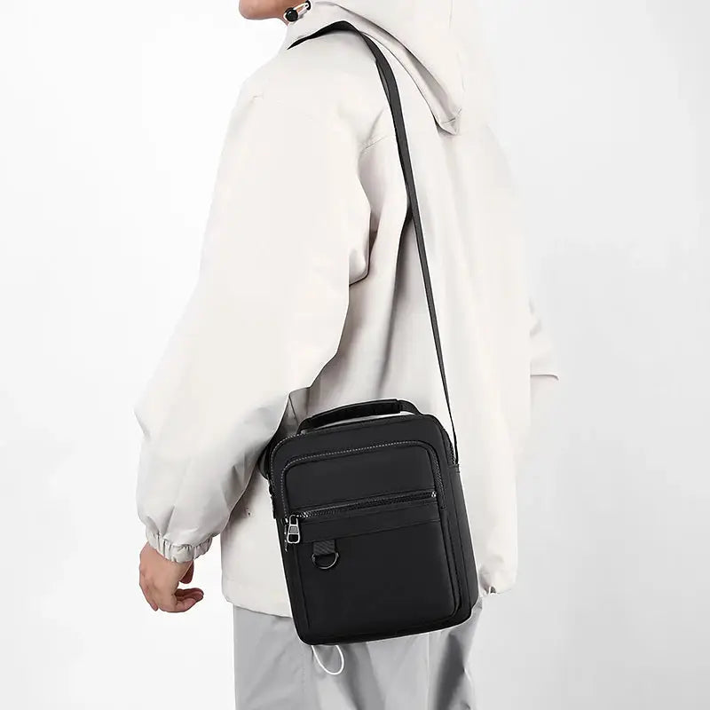 Simples Market messenger sling bag for men in black, compact crossbody with front zip pocket