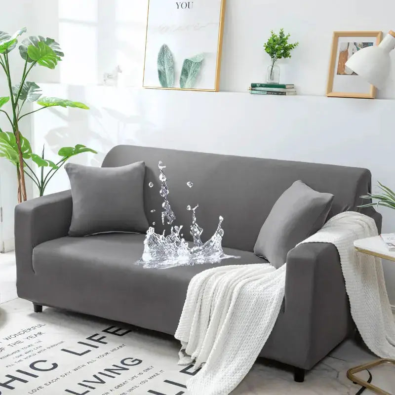 Simples Market gray waterproof stretch sofa cover for L-shaped corner couch; shown on a living room sofa with cushions and a cozy throw.