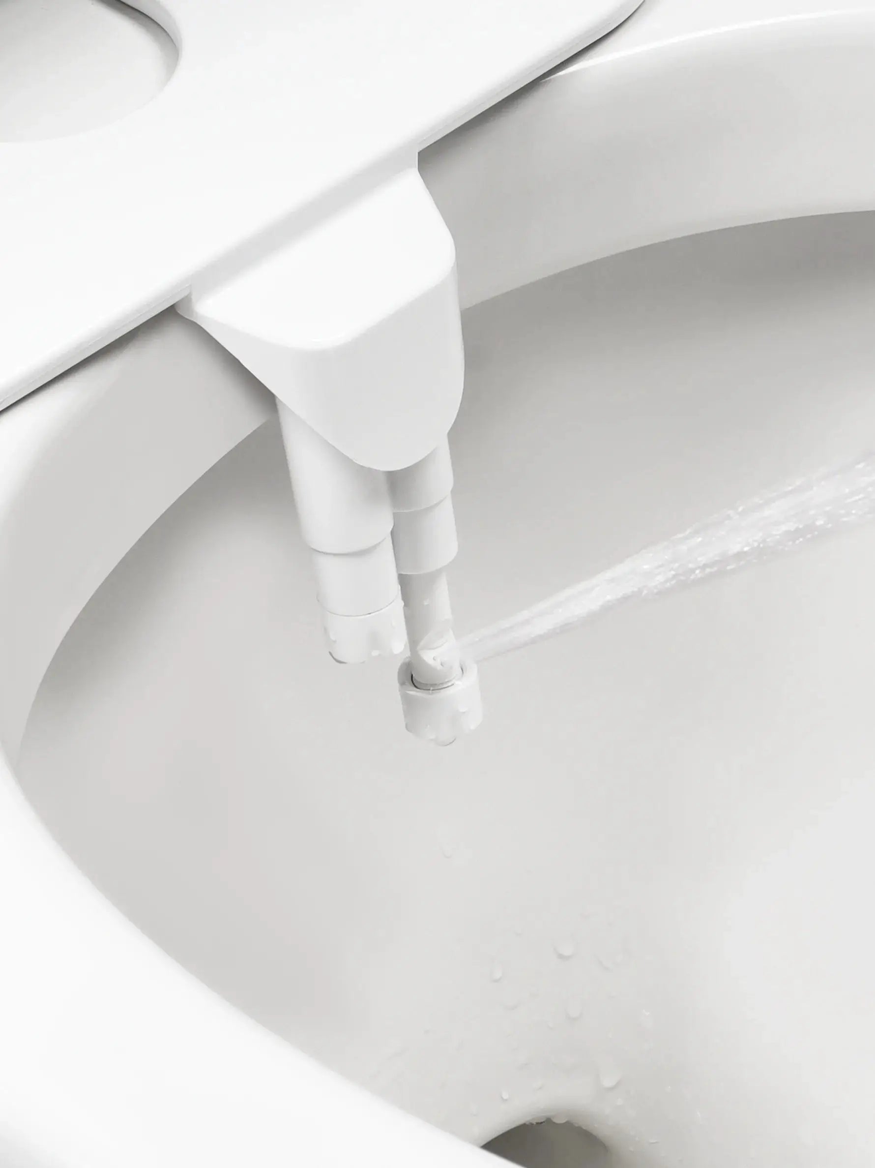 SAMODRA non-electric bidet seat attachment with dual nozzles on a white toilet