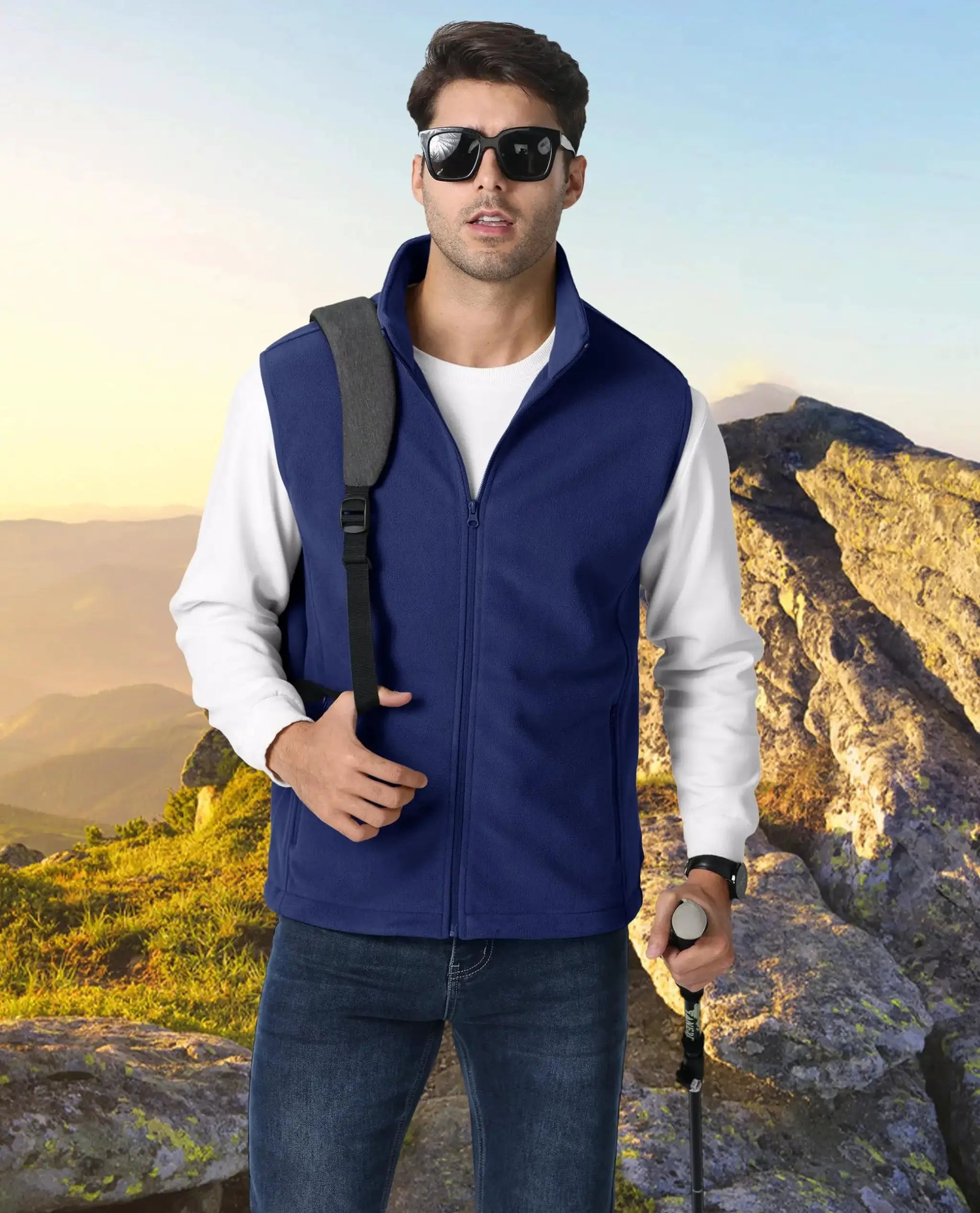 TACVASEN blue fleece vest, sleeveless outdoor jacket for hiking; man with backpack strap and trekking pole.