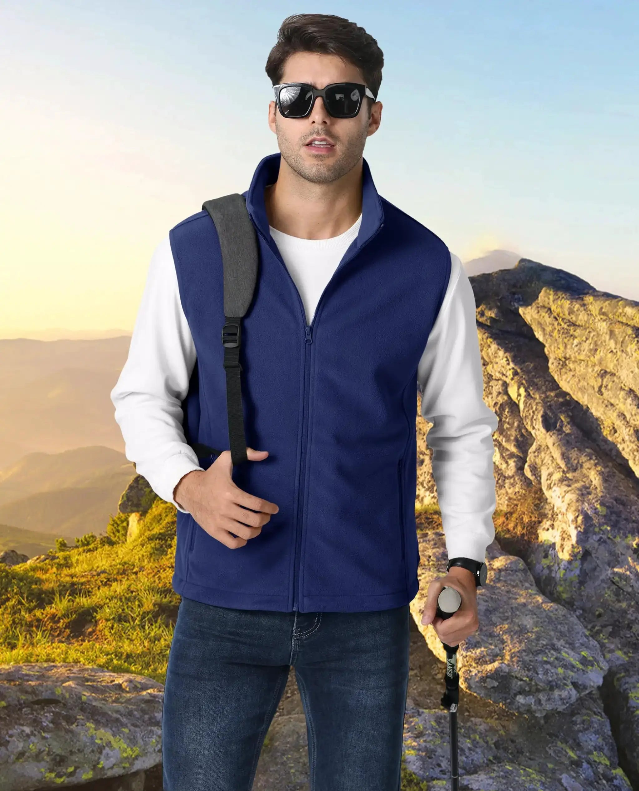 TACVASEN blue fleece vest, sleeveless outdoor jacket for hiking; man with backpack strap and trekking pole.
