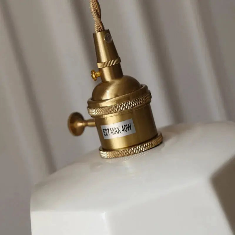 Brass vintage chandelier socket with knurled rings on a white ceramic shade, E27 max 40W.