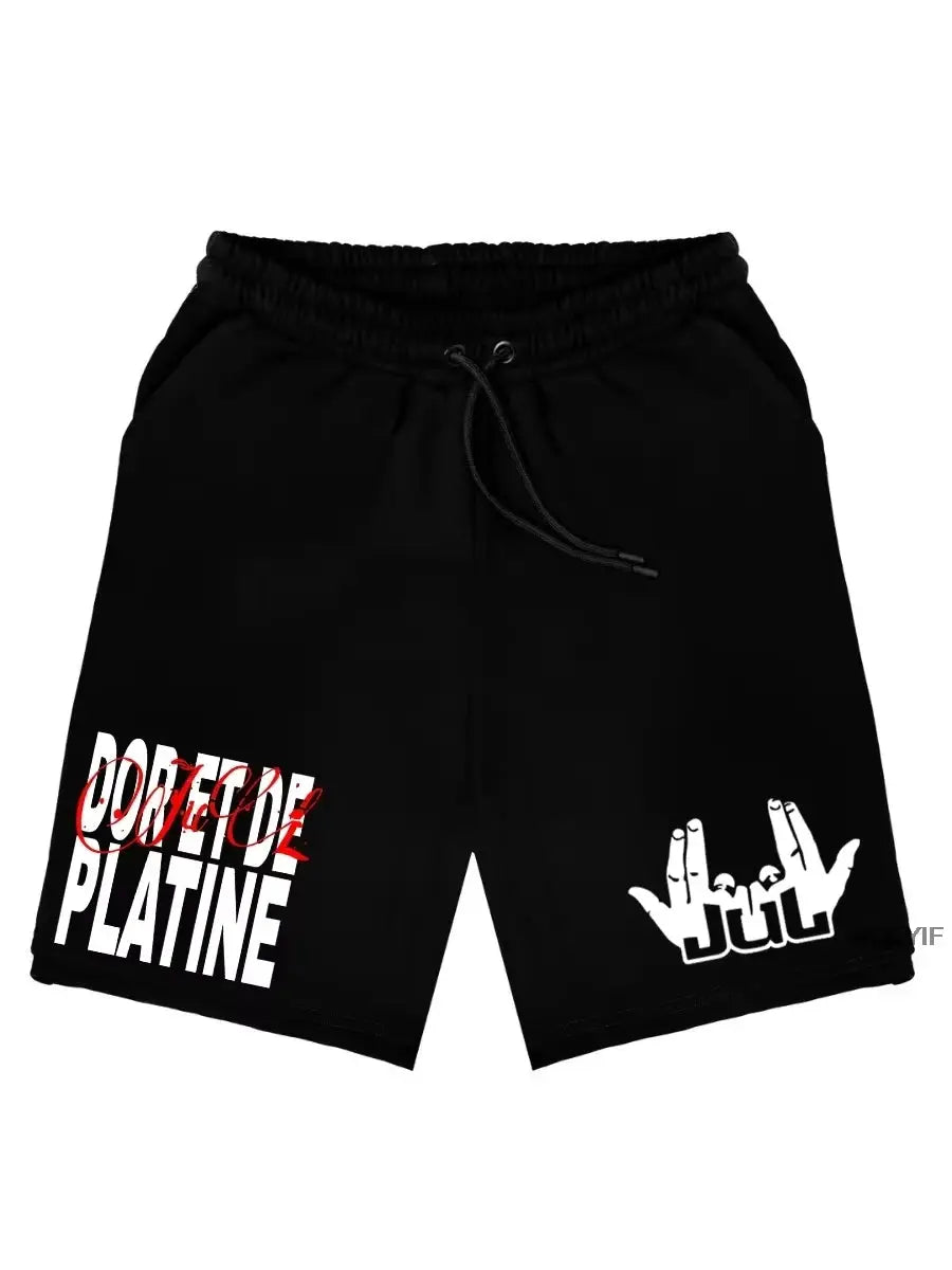 Jul shorts; black cotton shorts with drawstring, white left-leg graphics and a Jul hand logo on the right leg.