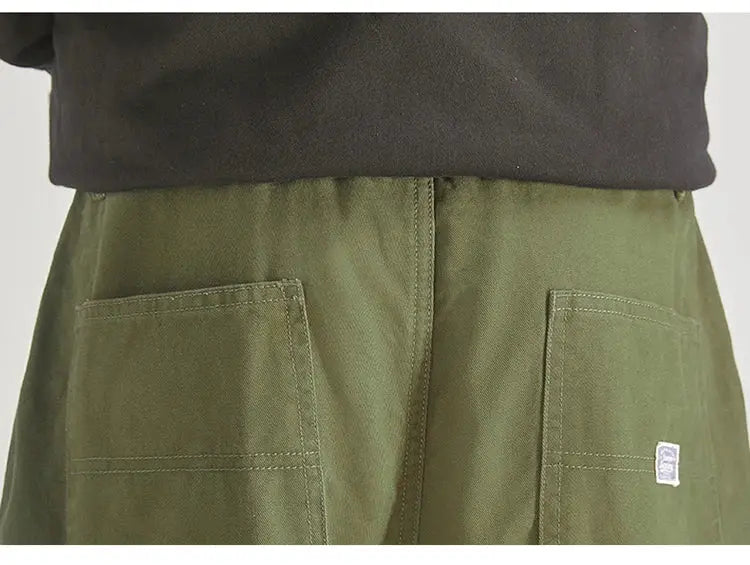 Men's olive cargo pants with large patch pockets, baggy fit.